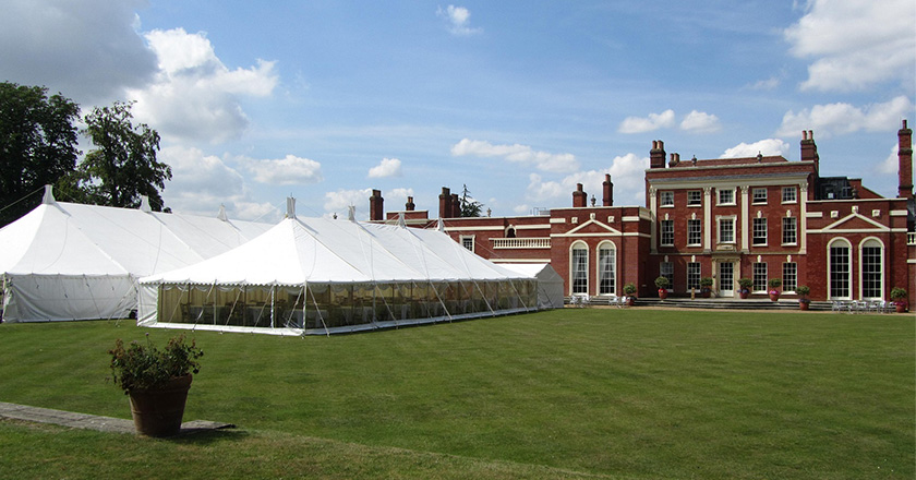 Two tent marquees on the back lawn of HInxton Hall
