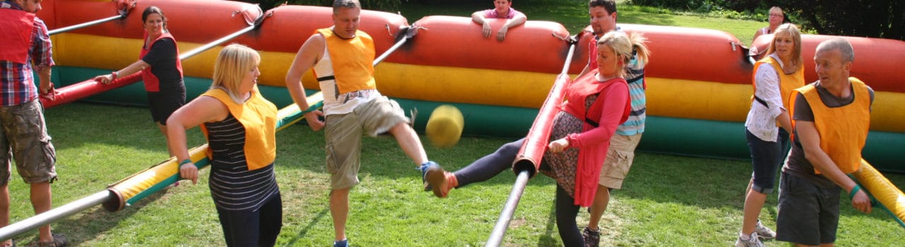 Photo of human table football team building event Photo of human table football team building event