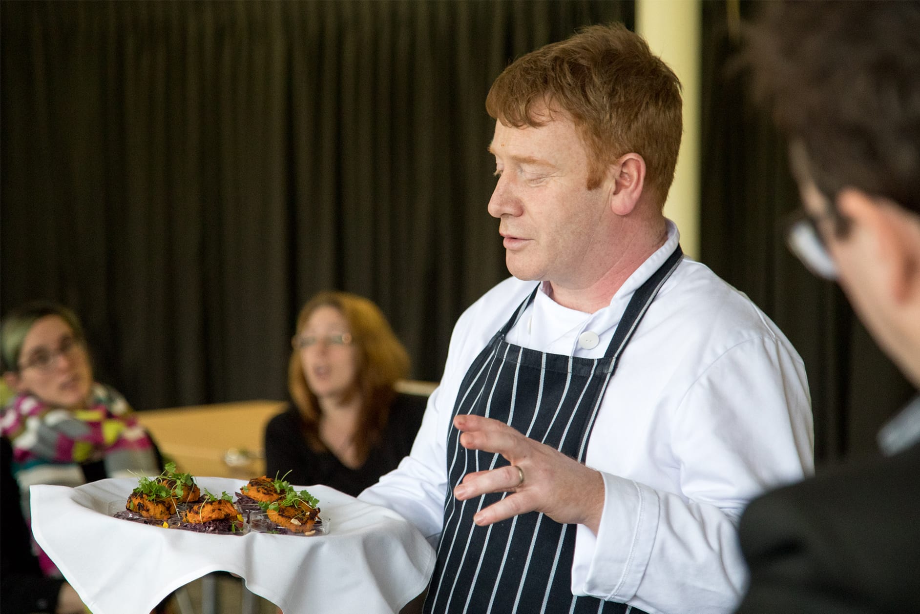 Head Chef presenting menu to colleagues