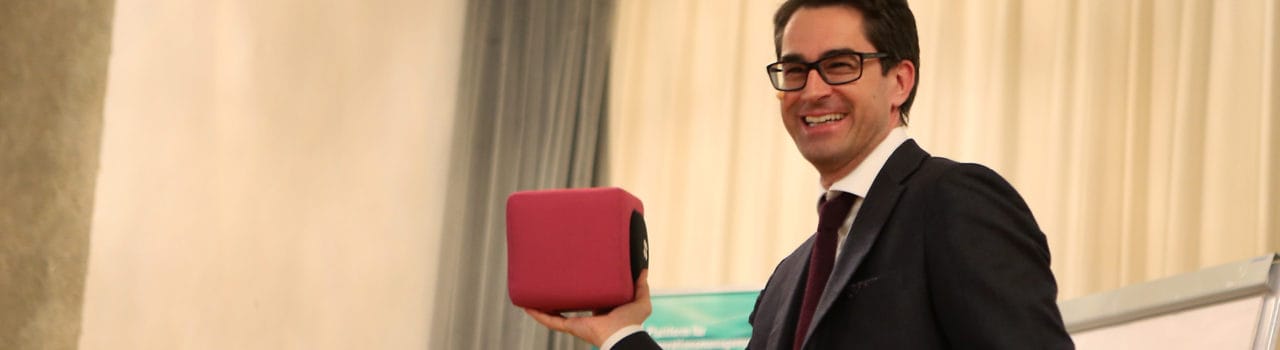 photo of a conference speaker holidng a Catchbox microphone photo of a conference speaker holidng a Catchbox microphone