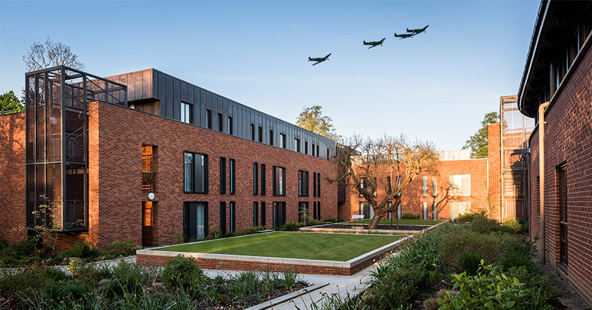 A photo of Mulberry Court accommodation block with spitire planes image transposed onto sky