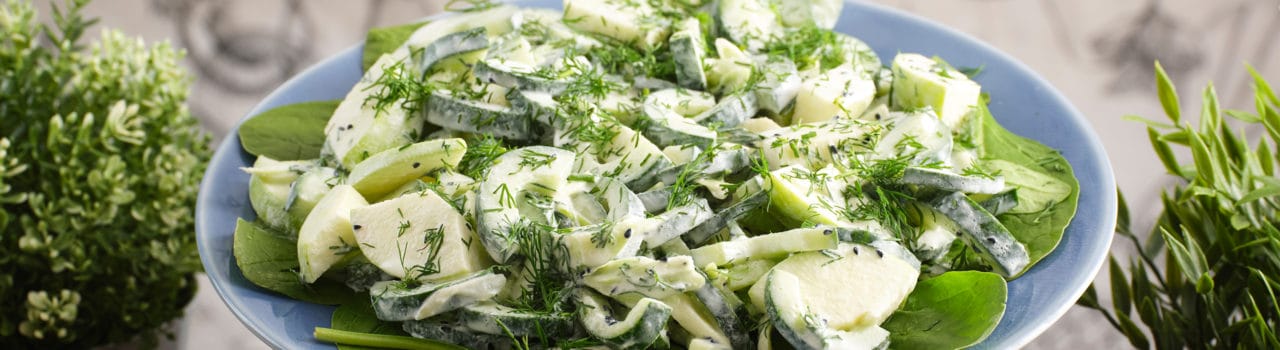 Close up for an apple, cucumber, and spinach salad