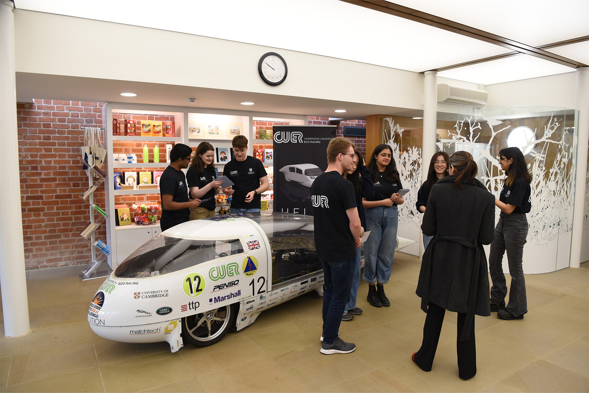Photo showing Cambridge University Eco Racing's Helia car and support team