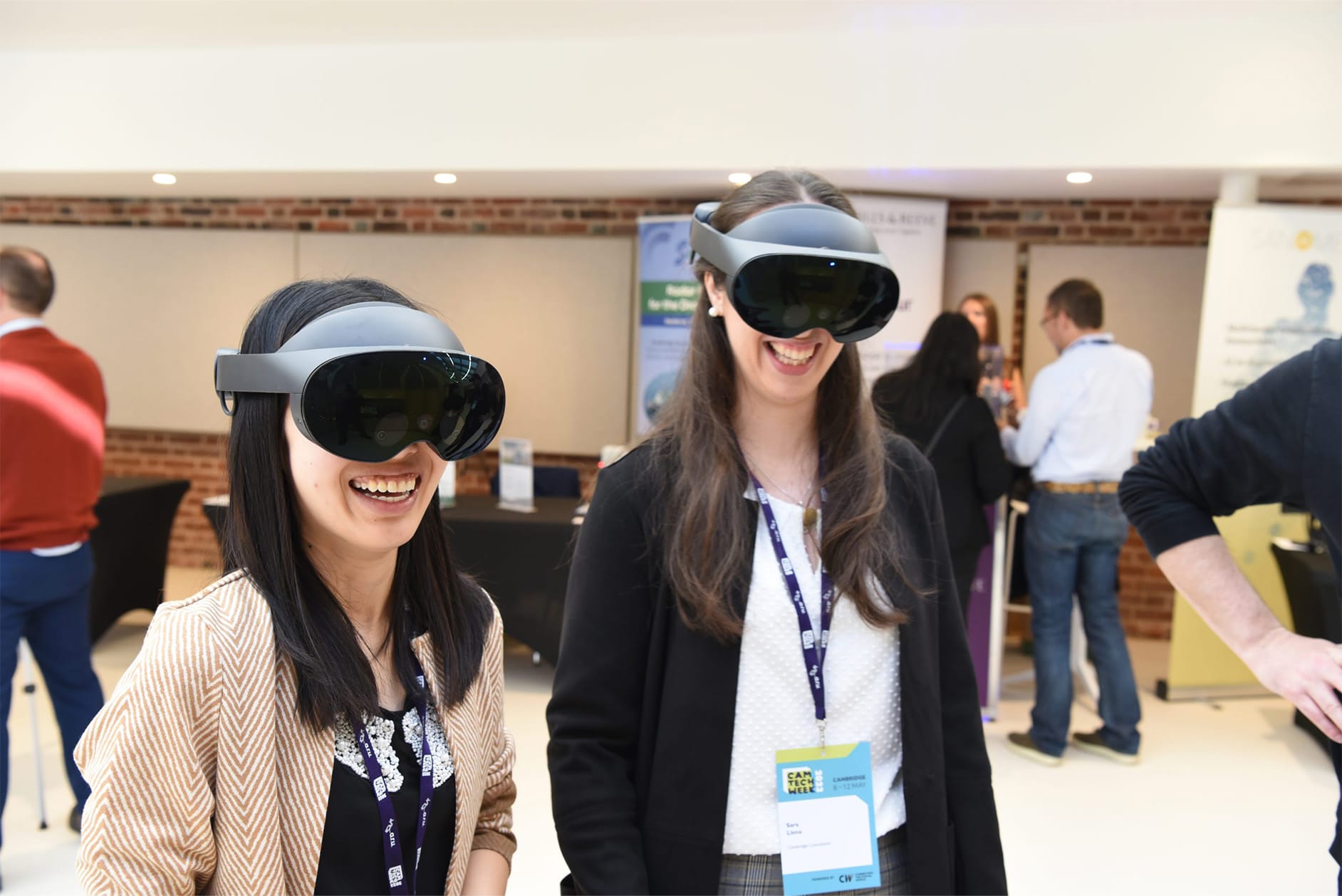 Two smiling, female delegates wearing VR headsets at Cam Tech Week Two smiling, female delegates wearing VR headsets at Cam Tech Week