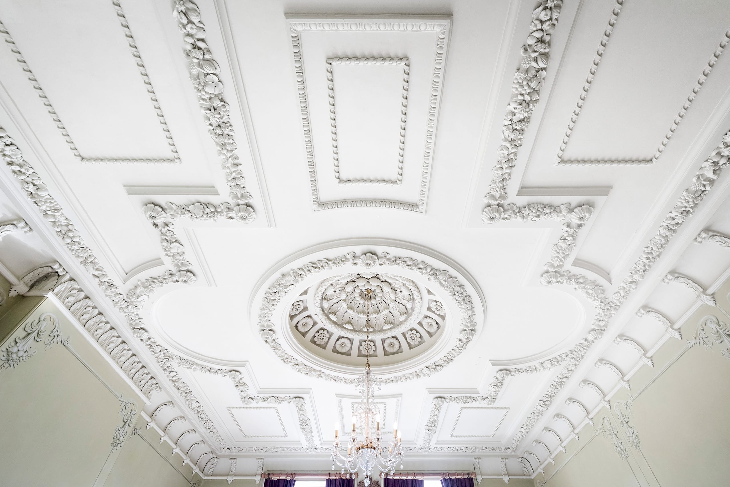 White ceiling with beautiful Rococo motifs with flowers and fruit White ceiling with beautiful Rococo motifs with flowers and fruit