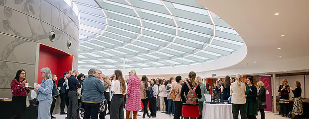 Delegates attending BIA Women in Tech 2025 standing and networking in the Event Space.