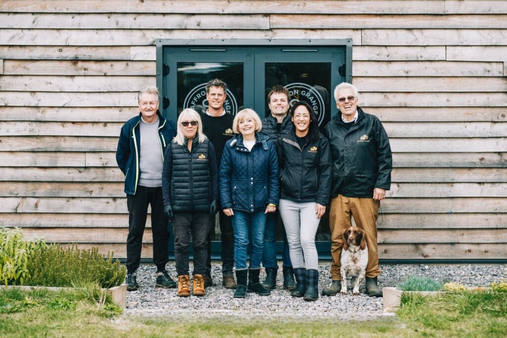 A selection of the Saffron Grange team: four men and three women. Standing outside the buildlng in winter clothes.