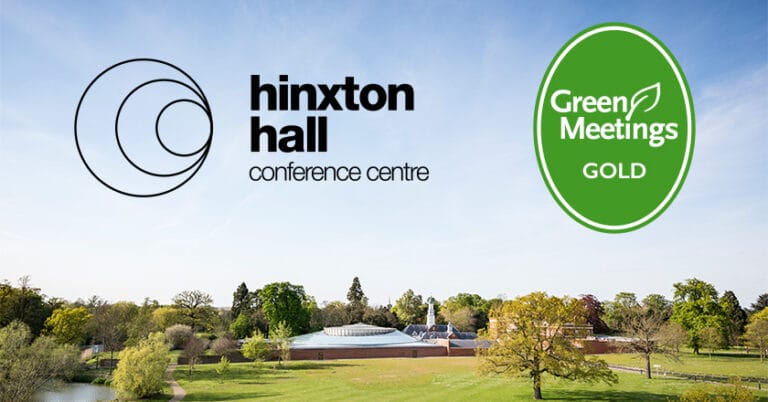 Photo with mostly blue sky, with the glass roof of Hinxton Hall Conference Centre in the distance. Two logos: Hinxton Hall Conference Centre and Green Meetings award GOLD.
